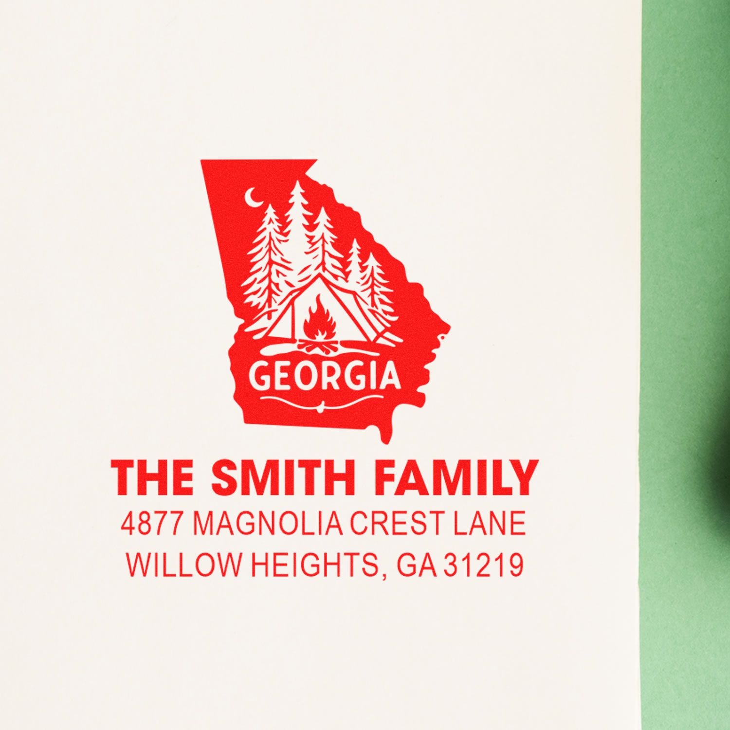 Custom Georgia return address rubber stamp with family name and address, featuring pine trees and campfire design.