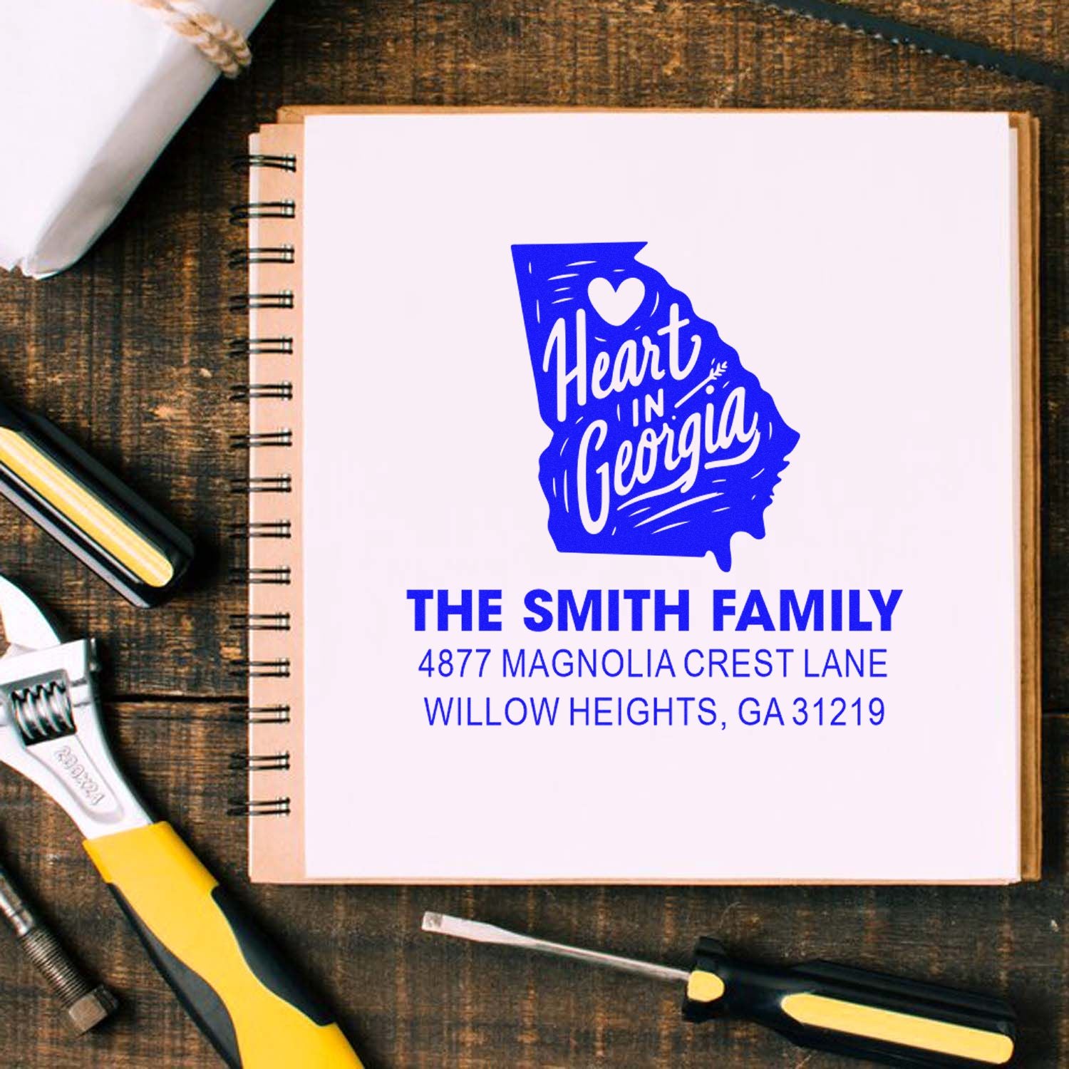 Personalized rubber stamp mockup with Georgia heart logo, The Smith Family name, and address for custom return address stamping.
