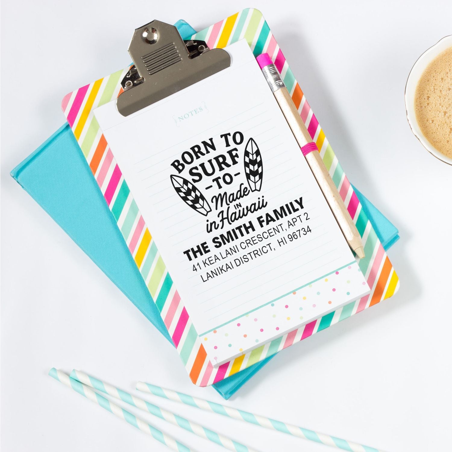 Custom rubber address stamp with surfboard design on notepad, featuring a Hawaii family return address for personalized stationery.