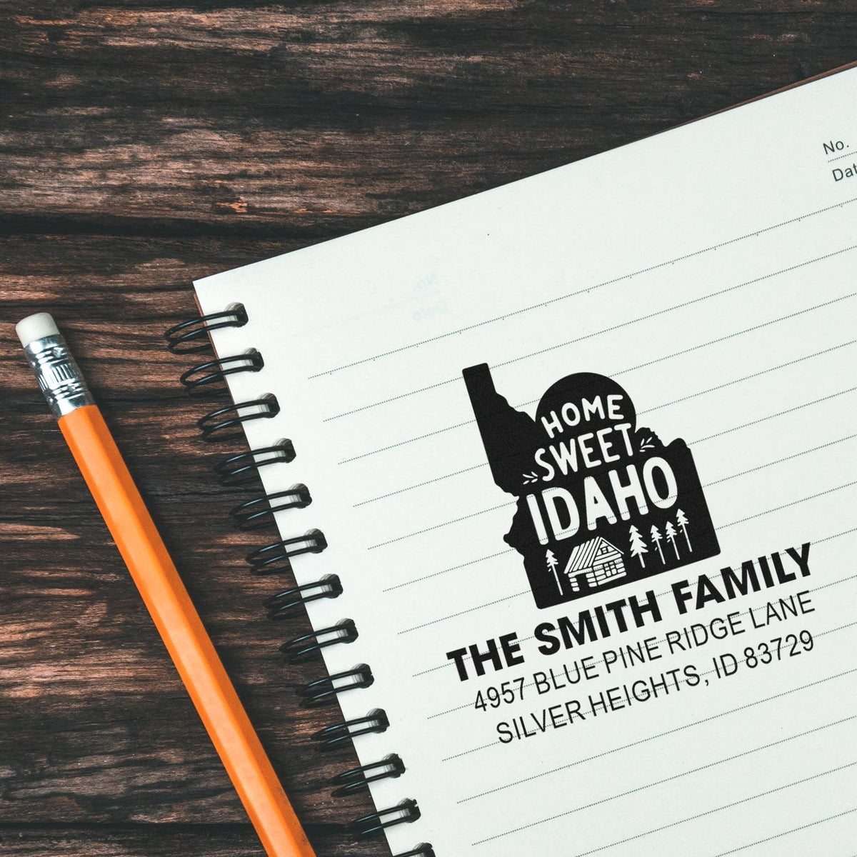 Custom rubber stamp with Home Sweet Idaho return address design for the Smith family on a notebook page.