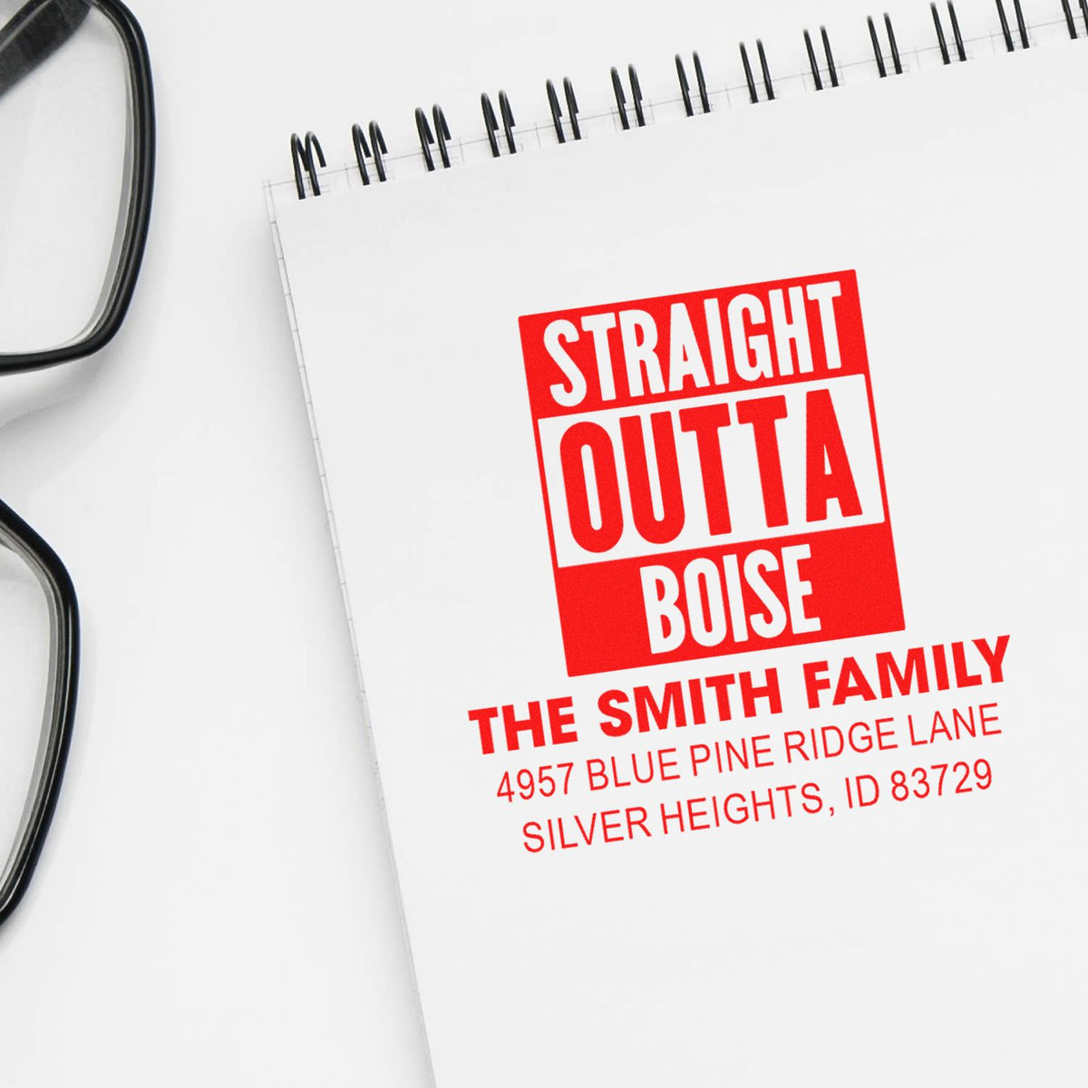 Custom rubber stamp design with Straight Outta Boise and The Smith Family return address on a notebook page