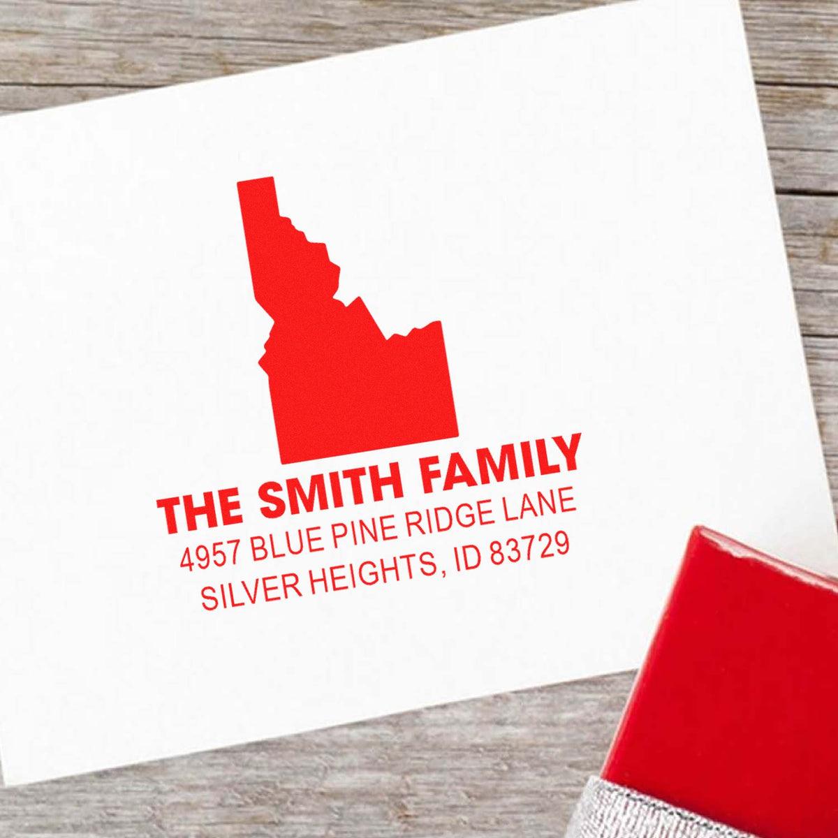 Custom Idaho return address rubber stamp for The Smith Family, featuring name, address and state silhouette in red ink.