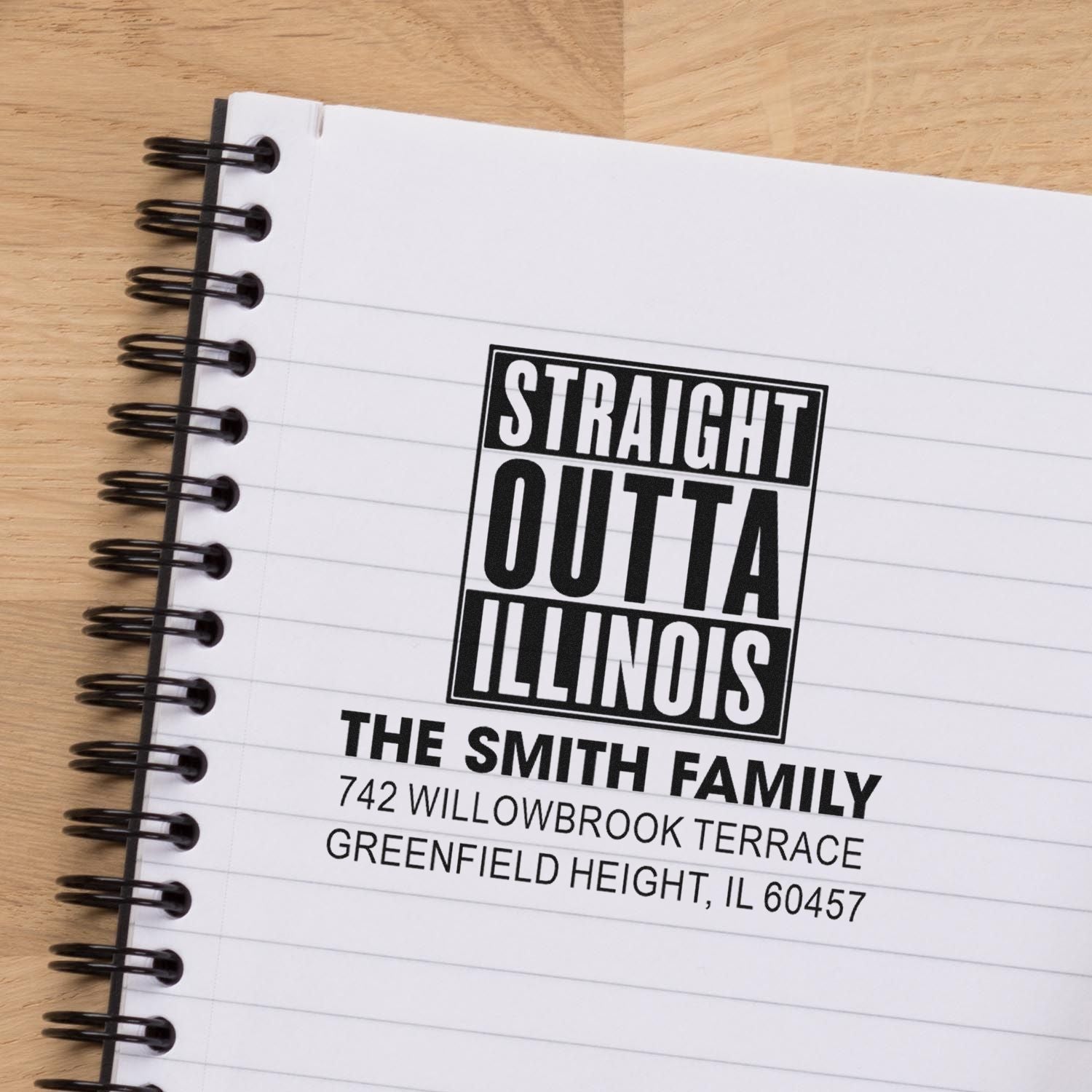 Custom rubber stamp address imprint on notebook reading Straight Outta Illinois for The Smith Family in Greenfield Height, IL.