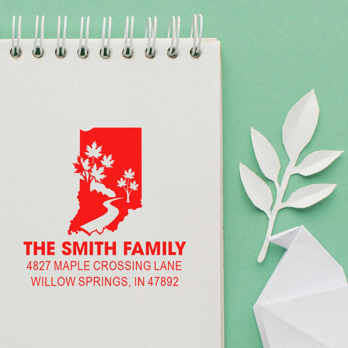 Custom return address rubber stamp with Indiana map design, The Smith Family name, and Willow Springs, IN address on notebook paper.