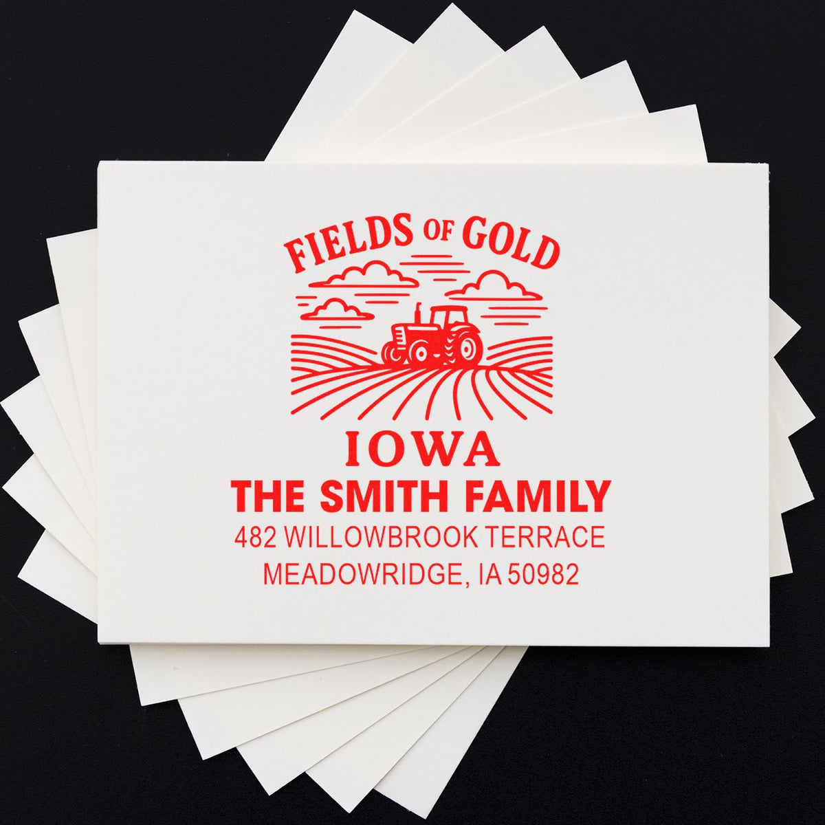 Custom return address rubber stamp with Iowa tractor logo, Smith Family name, and address on stacked envelopes.