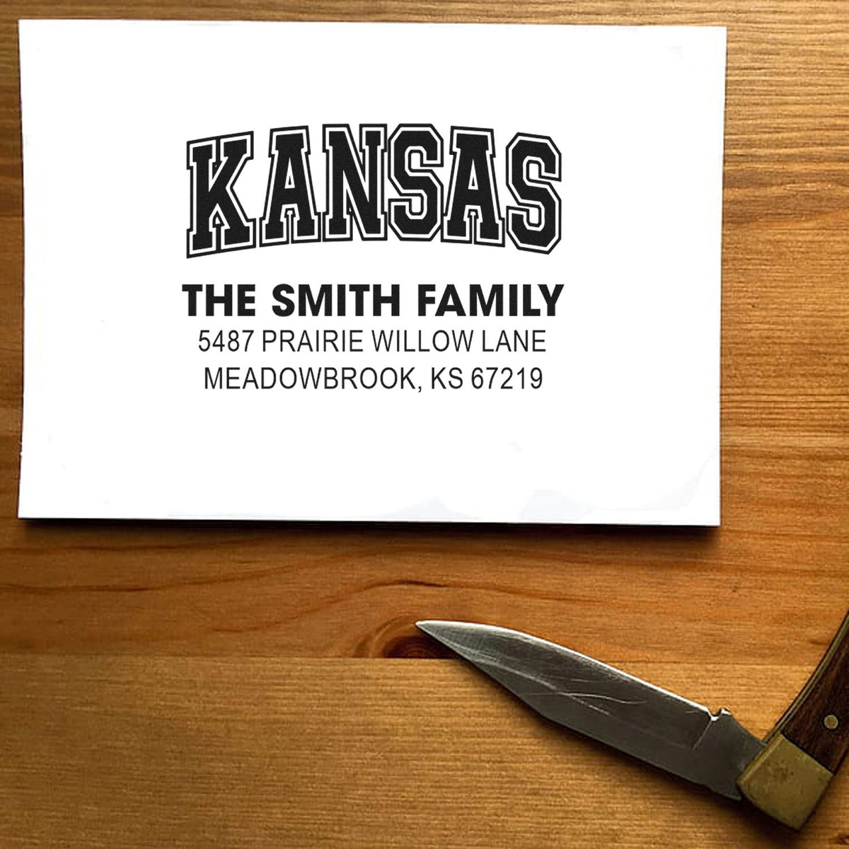 Custom Kansas return address rubber stamp with The Smith Family name and Meadowbrook, KS address on white paper.