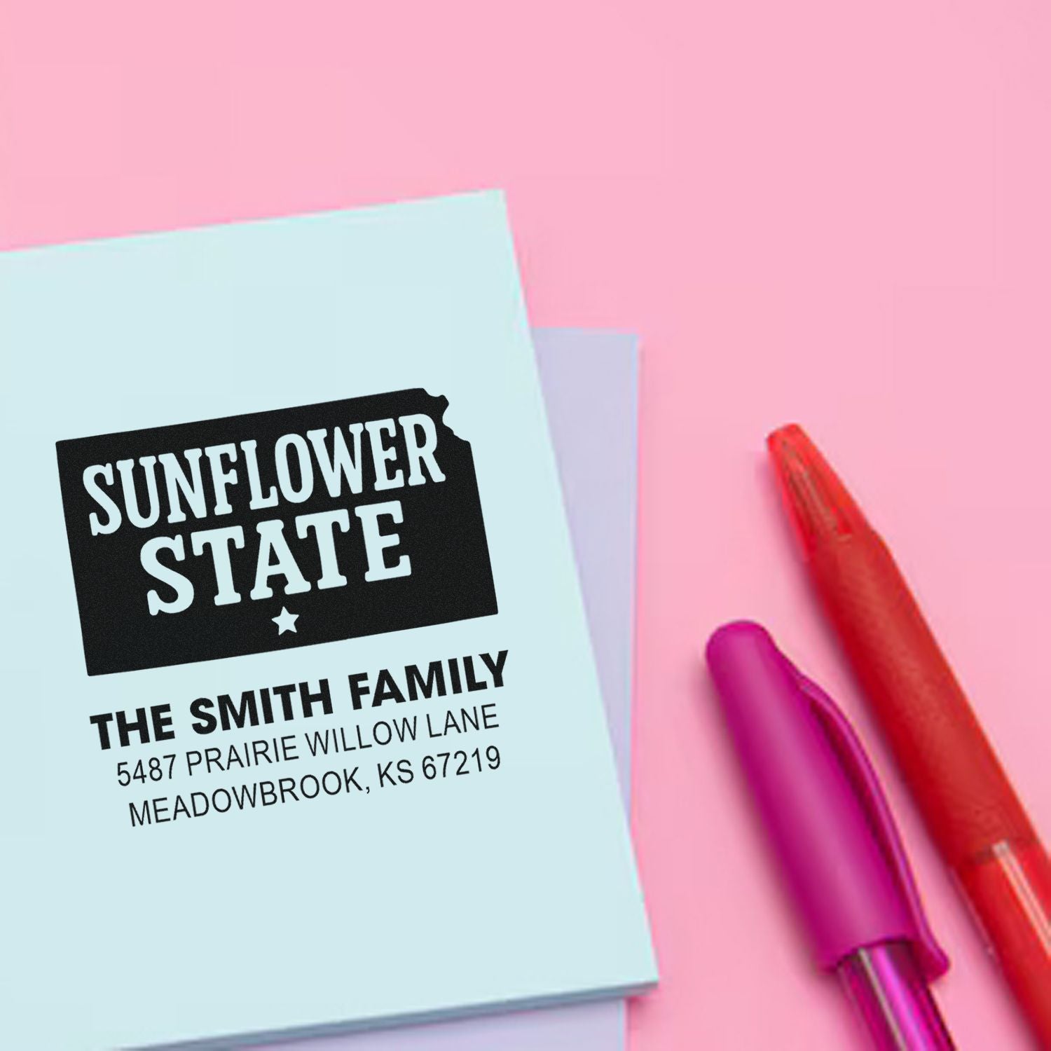 Custom return address rubber stamp for The Smith Family with Sunflower State design on pastel stationery.