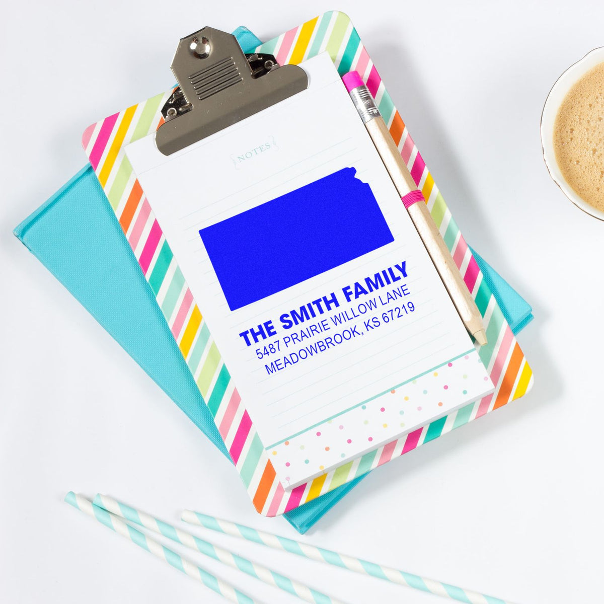 Custom address rubber stamp on colorful clipboard notebook for personalized stationery and mailing labels