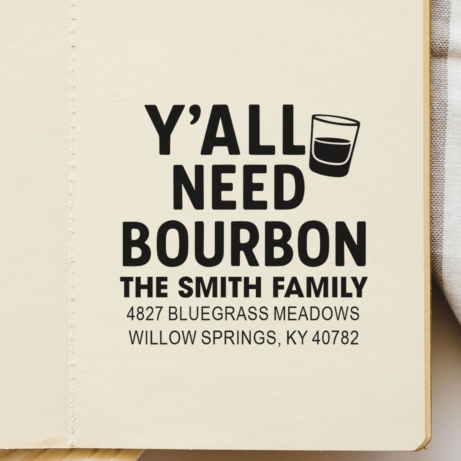 Custom rubber stamp for home bar gifts, reading Yall Need Bourbon with shot glass icon and family name/address.