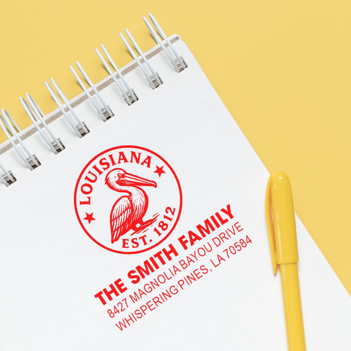 Custom family address rubber stamp with pelican logo on notebook for personalized stationery.