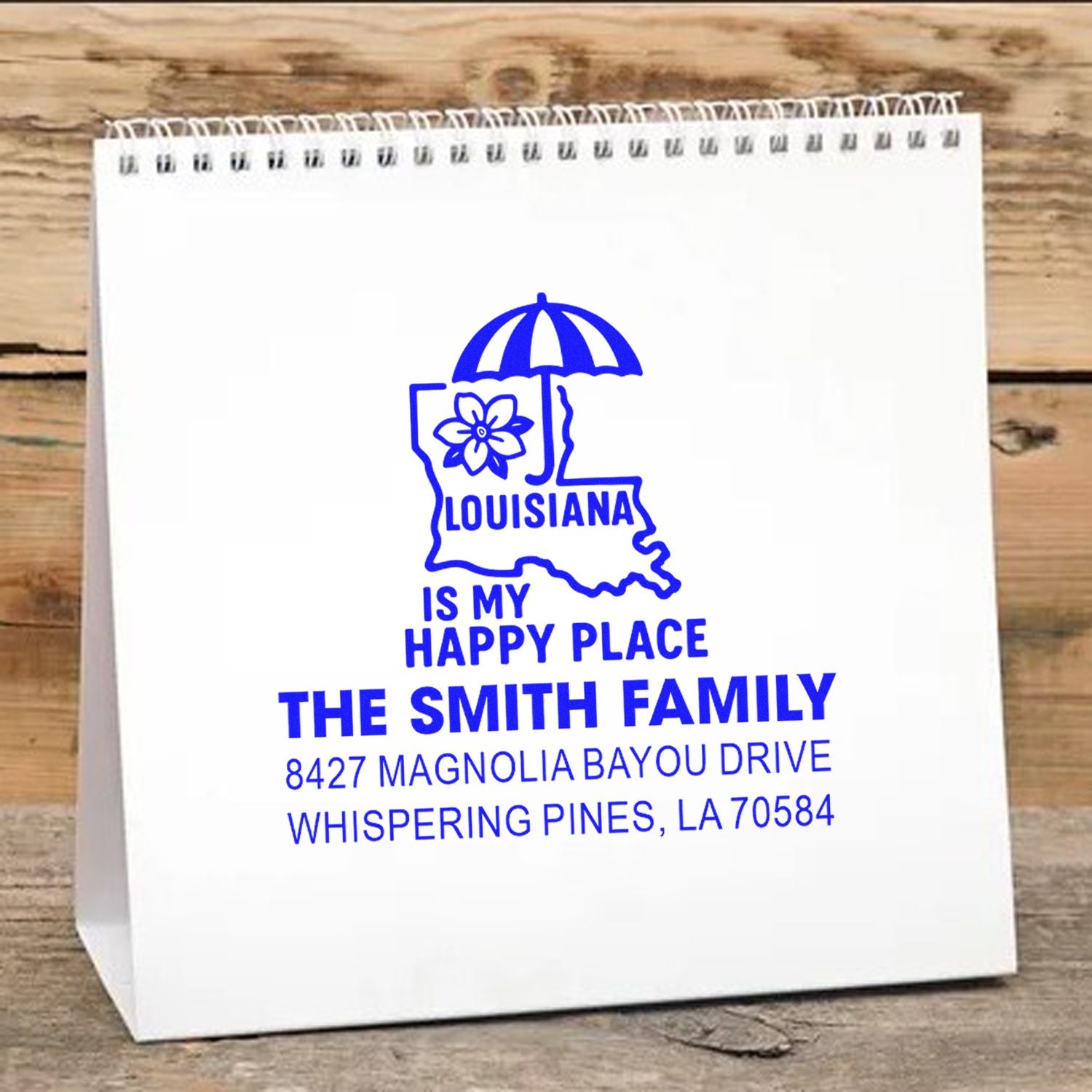 Custom rubber stamp design on gift bag with Louisiana Is My Happy Place, The Smith Family, and address in blue.