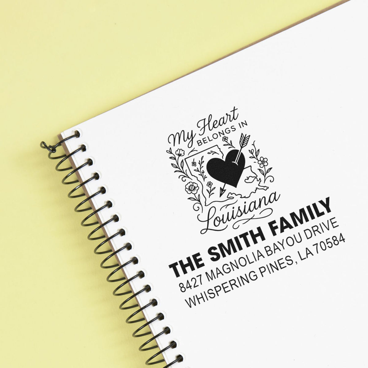 Custom family address rubber stamp on notebook, featuring Louisiana heart graphic and Smith family return address design.