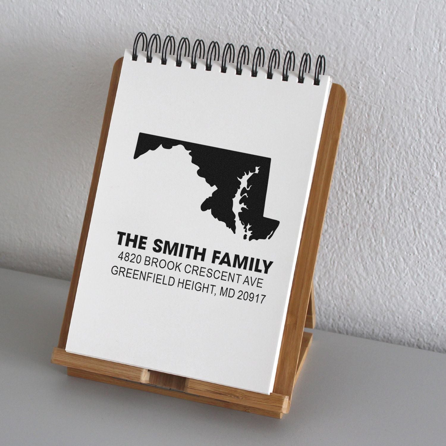 Custom family address rubber stamp with Maryland state outline, ideal for personalized return mail and stationery.