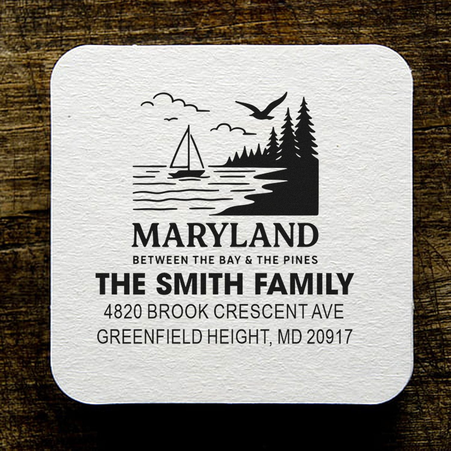 Personalized Maryland return address rubber stamp with sailboat and pine tree design for family mail.