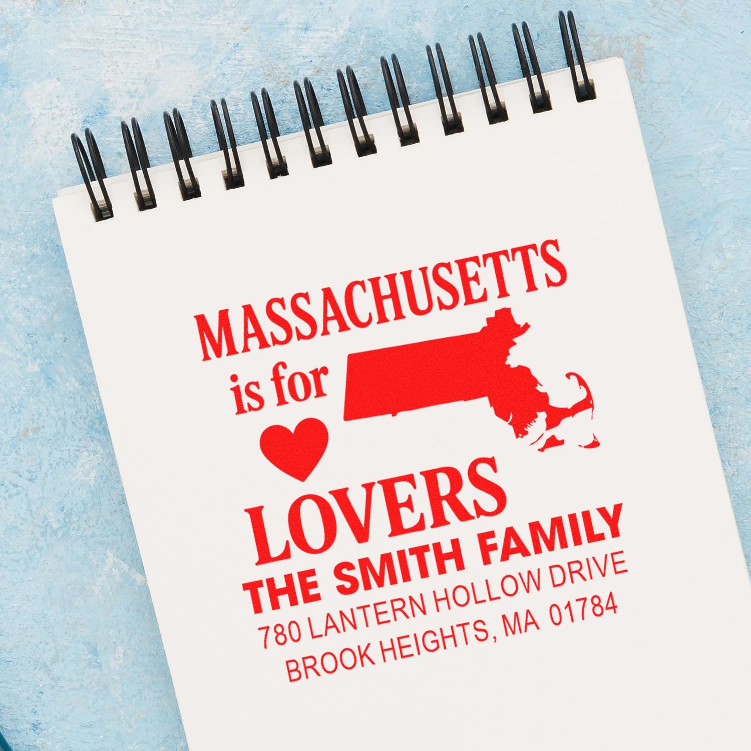 Custom Massachusetts rubber stamp imprint with state map, heart, family name, and return address