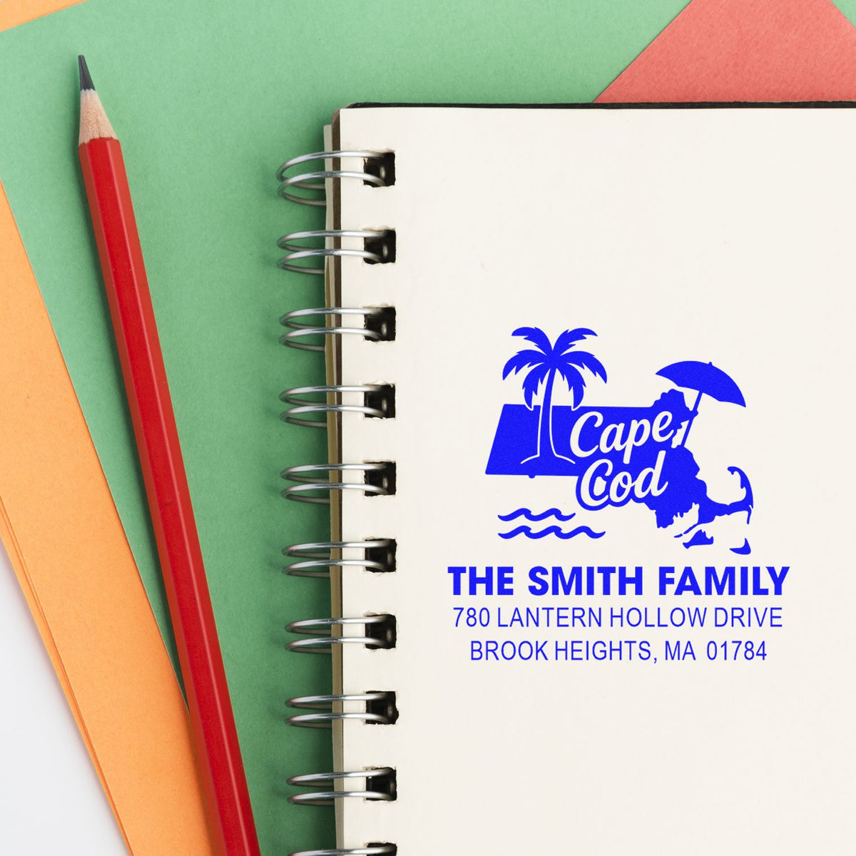 Custom Cape Cod personalized return address rubber stamp for The Smith Family on a spiral notebook.