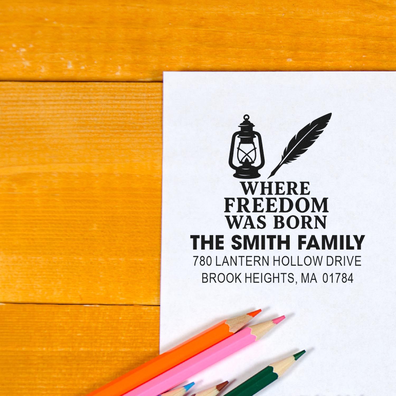 Custom return address rubber stamp proof for The Smith Family with lantern and feather design on white paper.