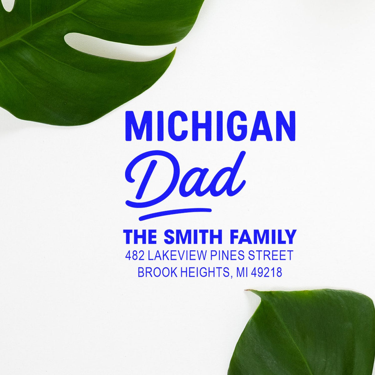 Custom Michigan Dad rubber stamp with The Smith Family name and address, framed by tropical leaves.