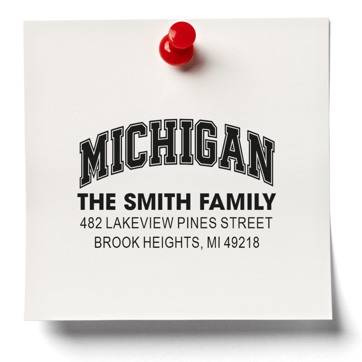 Personalized return address rubber stamp with Michigan family name and custom mailing address on white paper.
