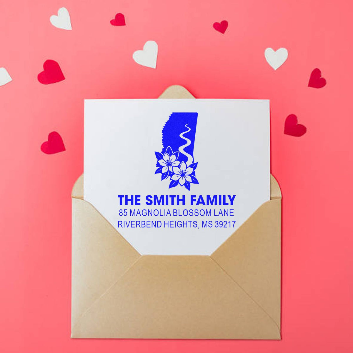 Custom return address rubber stamp on envelope with floral initial and family address, perfect for wedding or holiday mail.