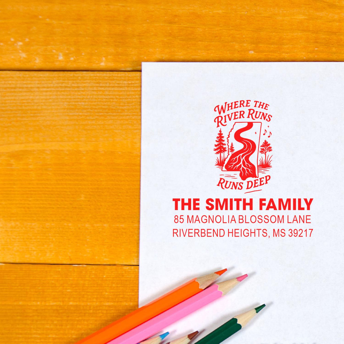 Personalized rubber address stamp for The Smith Family, featuring a custom logo and return address on white paper.