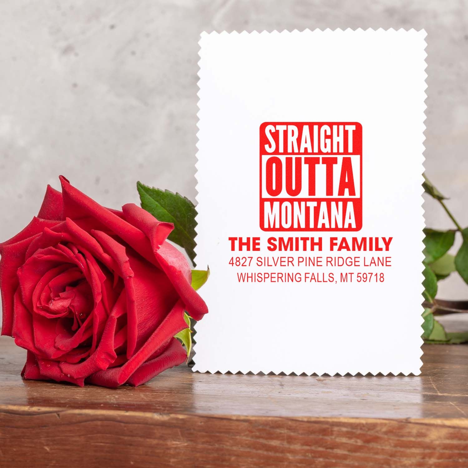 Custom family return address rubber stamp with Straight Outta Montana design, shown on a sample card with a rose.
