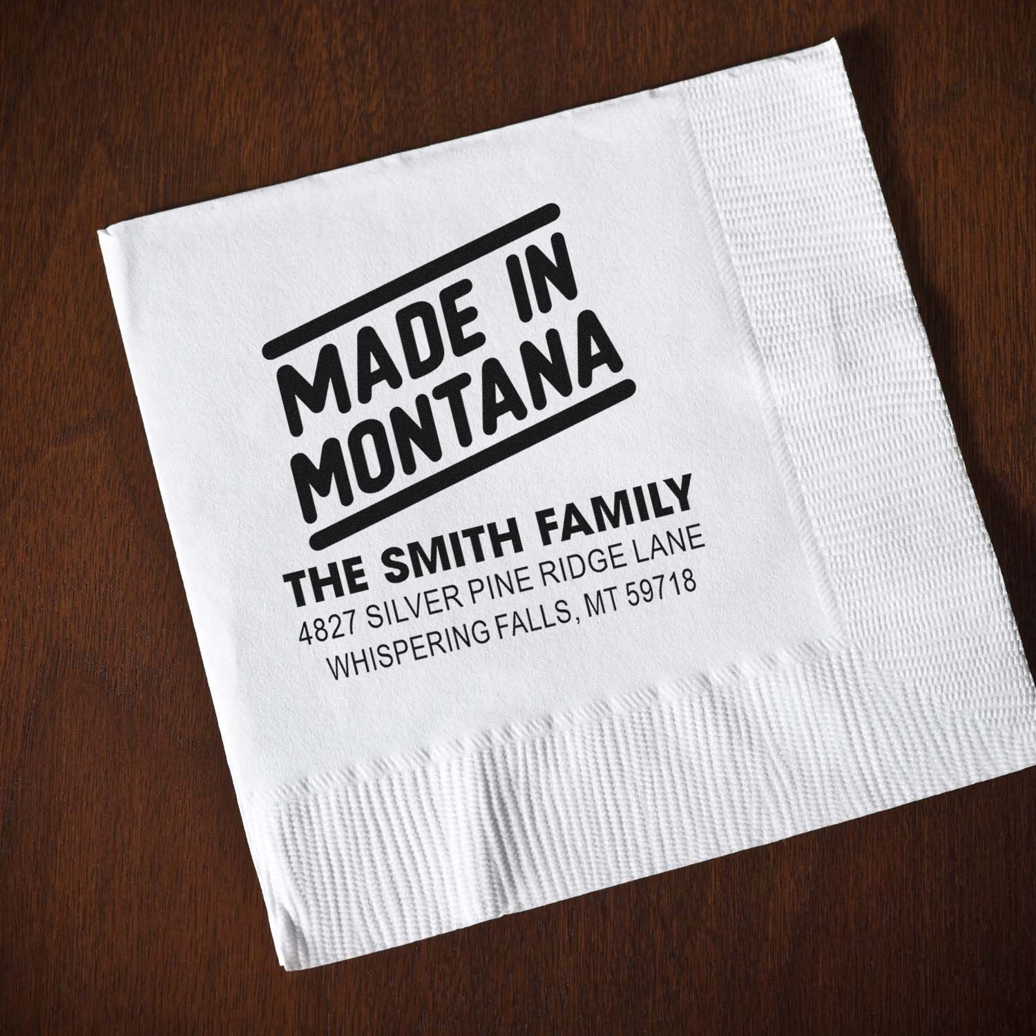 Custom rubber stamp design on napkin reading Made in Montana for The Smith Family, personalized address stamp.