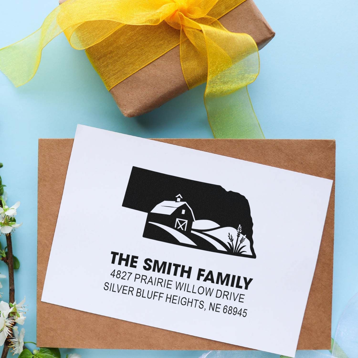 Custom farm return address rubber stamp on envelope with personalized family name and mailing address.