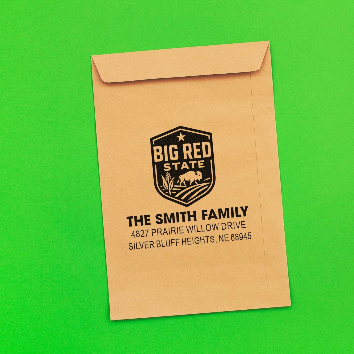 Custom family return address rubber stamp on envelope with logo, name, and Nebraska mailing address.