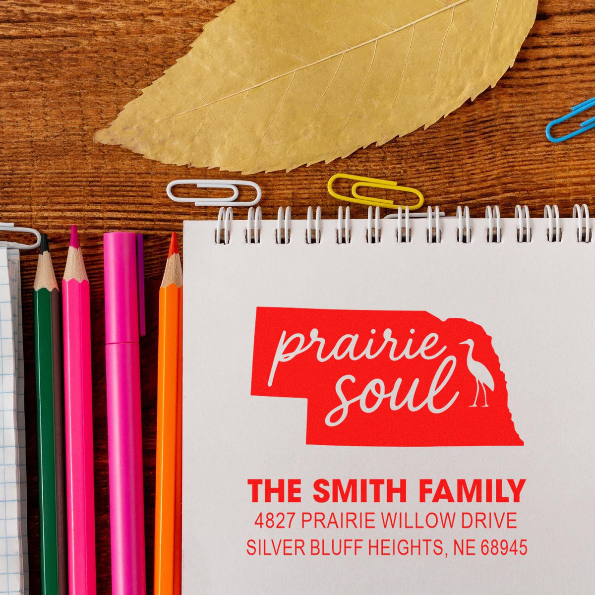 Custom rubber stamp design for The Smith Family with Prairie Soul Nebraska return address on a notebook.