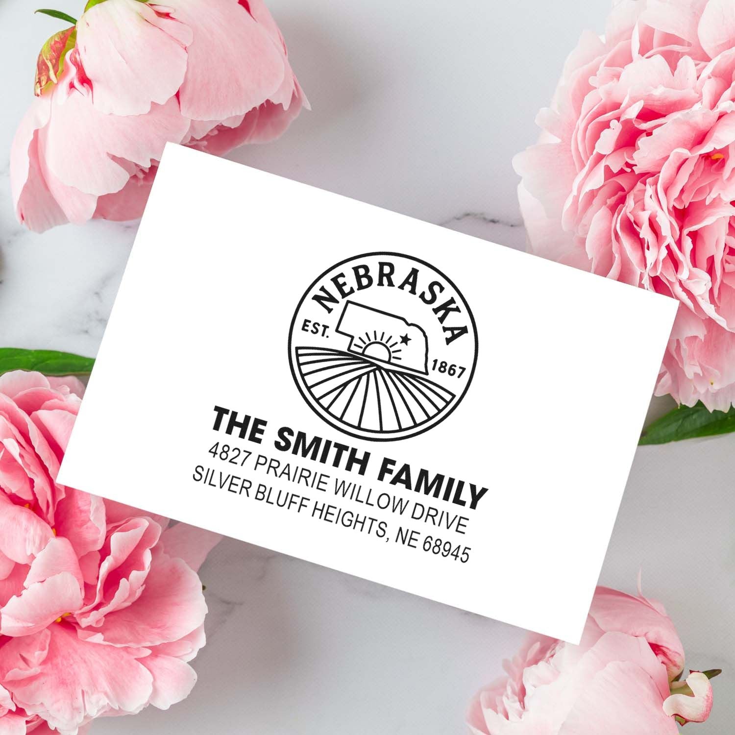 Custom Nebraska return address rubber stamp for The Smith Family with logo and mailing address for envelopes