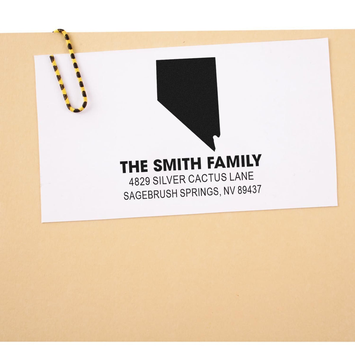 Custom Nevada return address rubber stamp on envelope for The Smith Family, personalized mailing stamp with name and address.