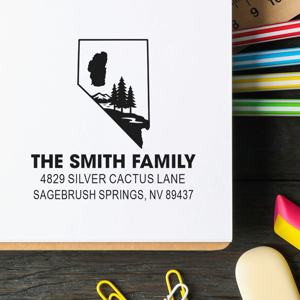 Custom family return address rubber stamp with Nevada state design and trees for personalized mailing.