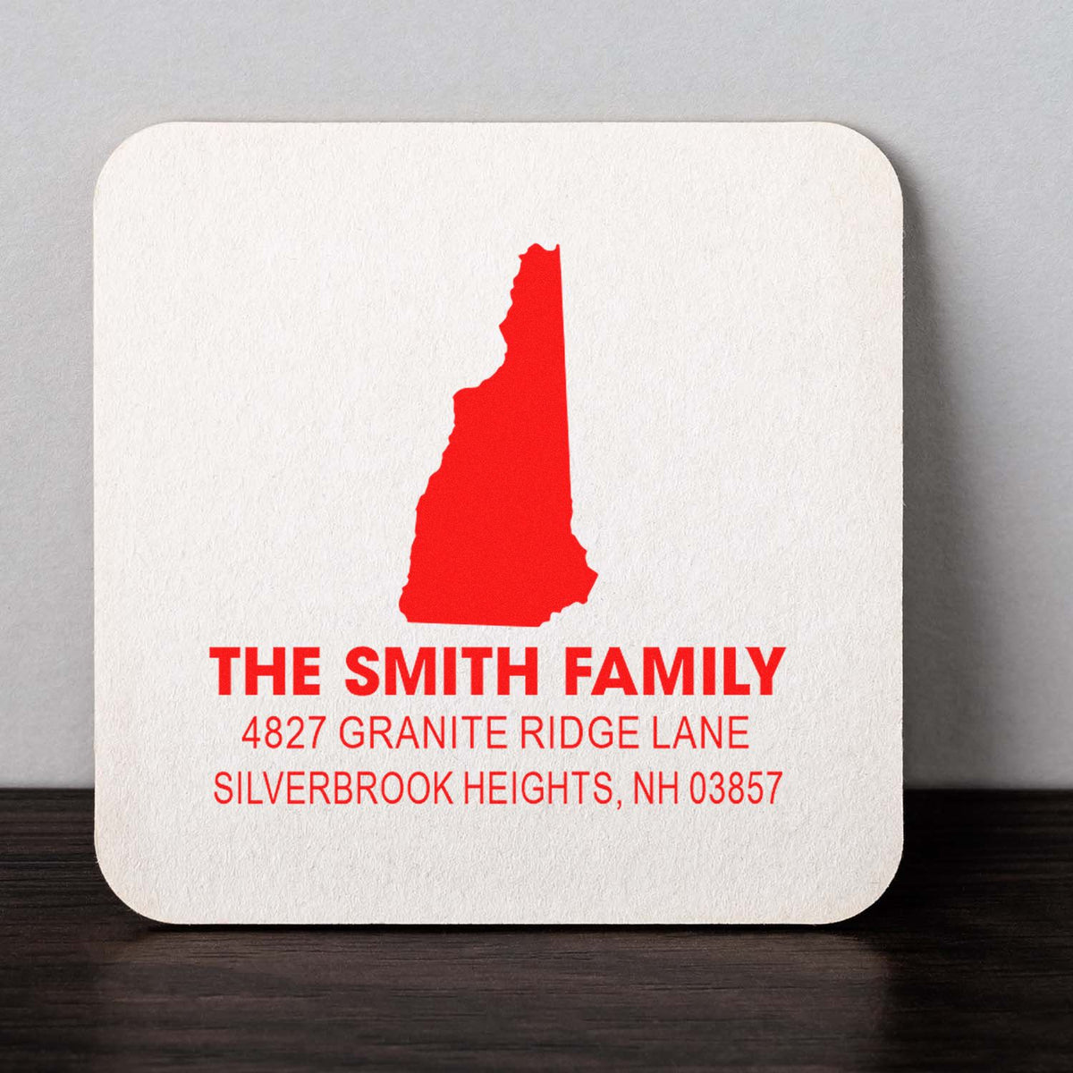 Custom return address rubber stamp for The Smith Family, featuring New Hampshire silhouette and personalized home address.
