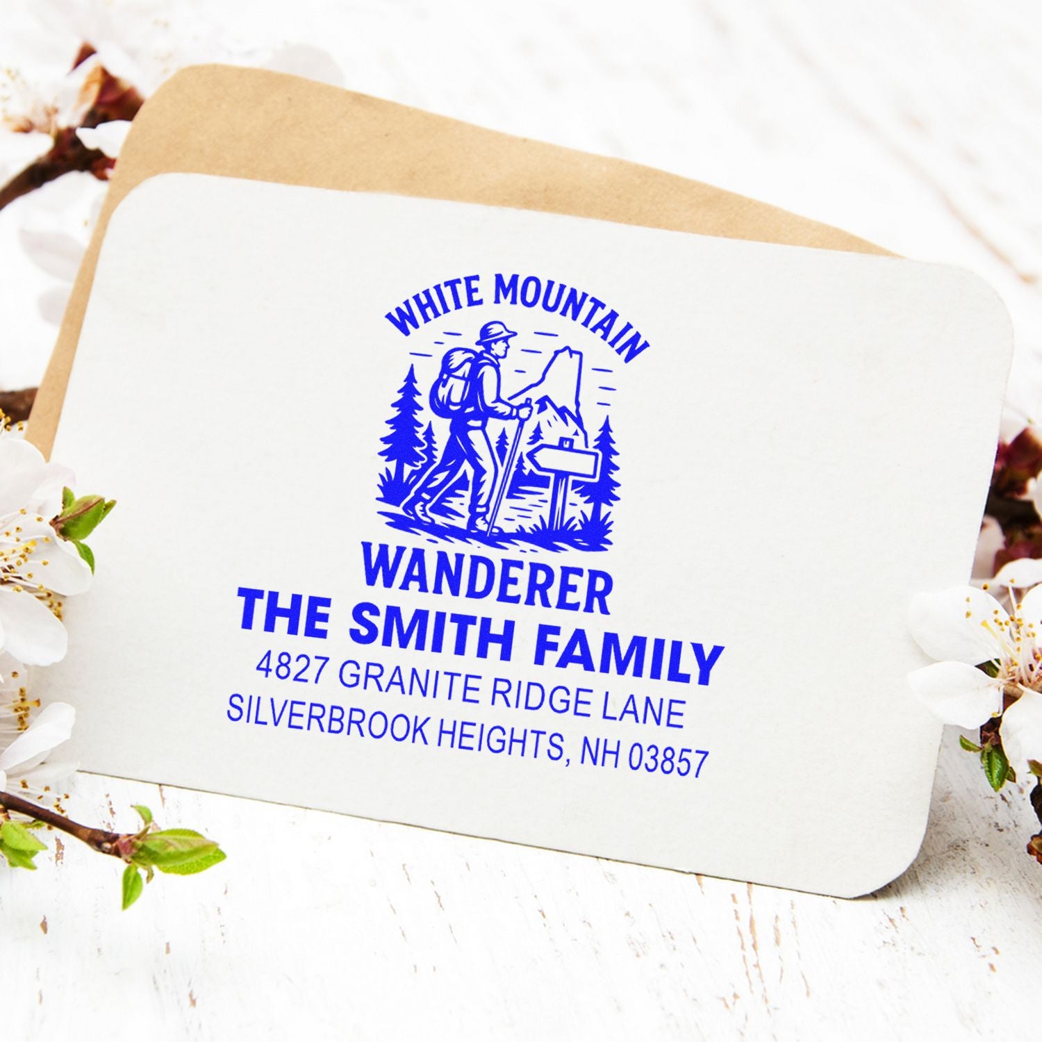 Custom family address rubber stamp with White Mountain Wanderer hiking logo and return address.