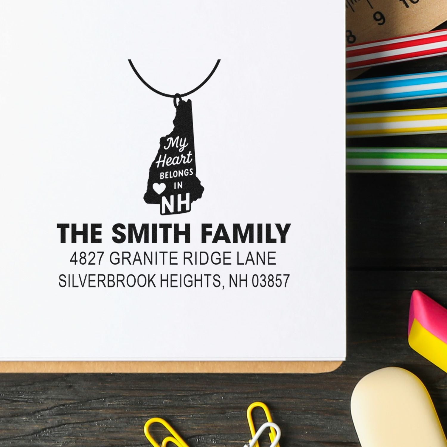 Personalized address rubber stamp for The Smith Family with New Hampshire state design and custom return address.