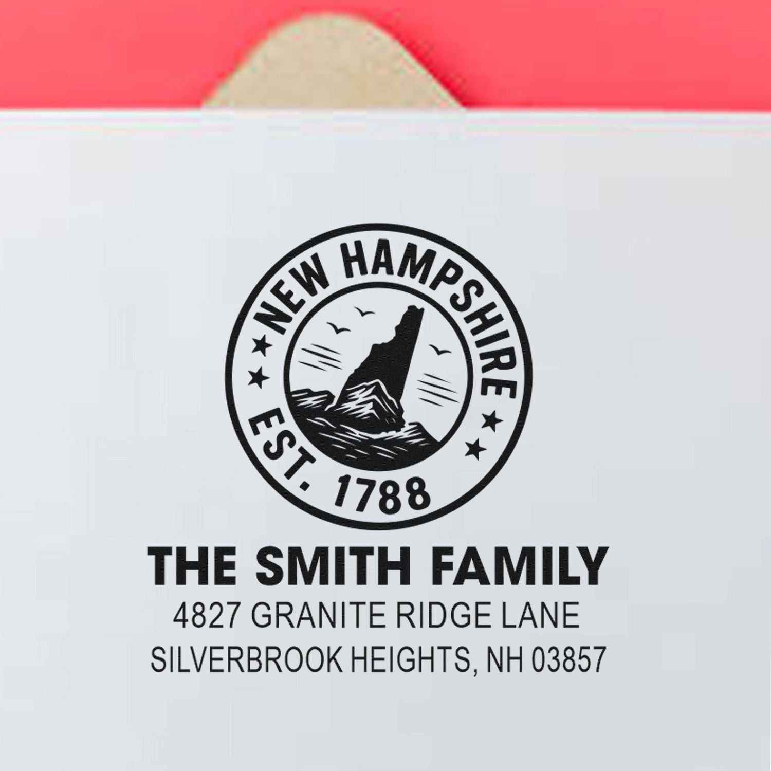Custom rubber return address stamp for The Smith Family, Silverbrook Heights, NH 03857, featuring New Hampshire state seal.