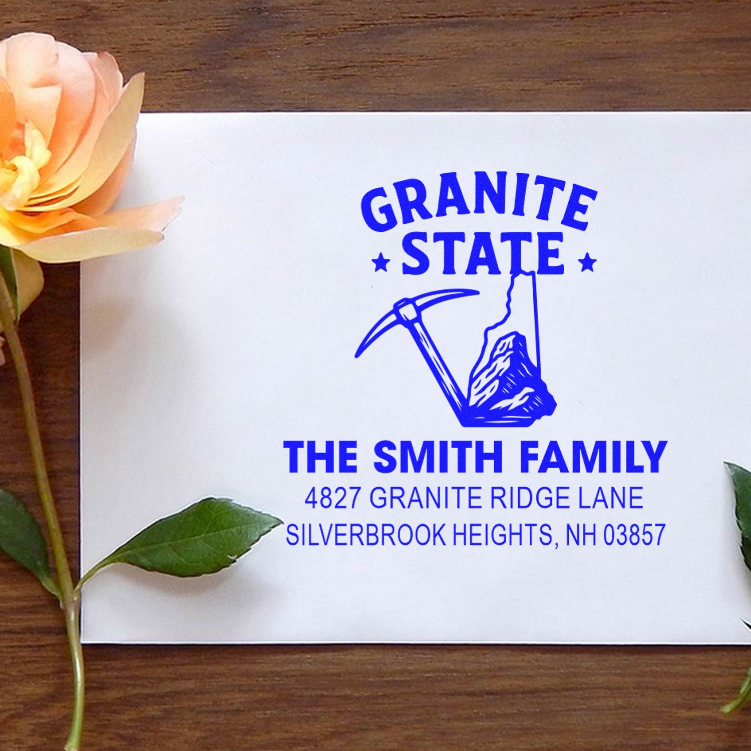 Custom Granite State family return address rubber stamp for New Hampshire mailings, with pickaxe logo and address.