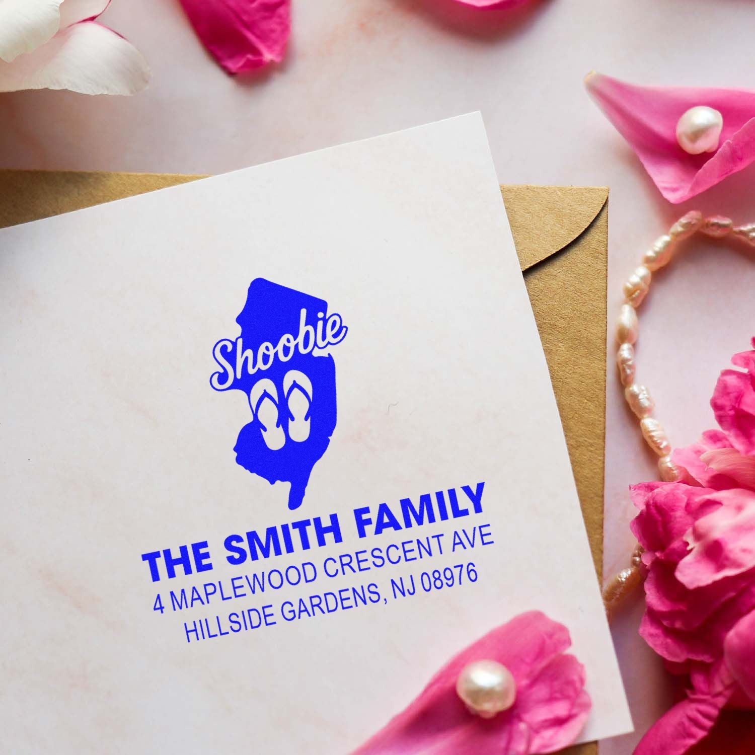 Personalized return address rubber stamp for The Smith Family on a wedding envelope with Shoobie design.