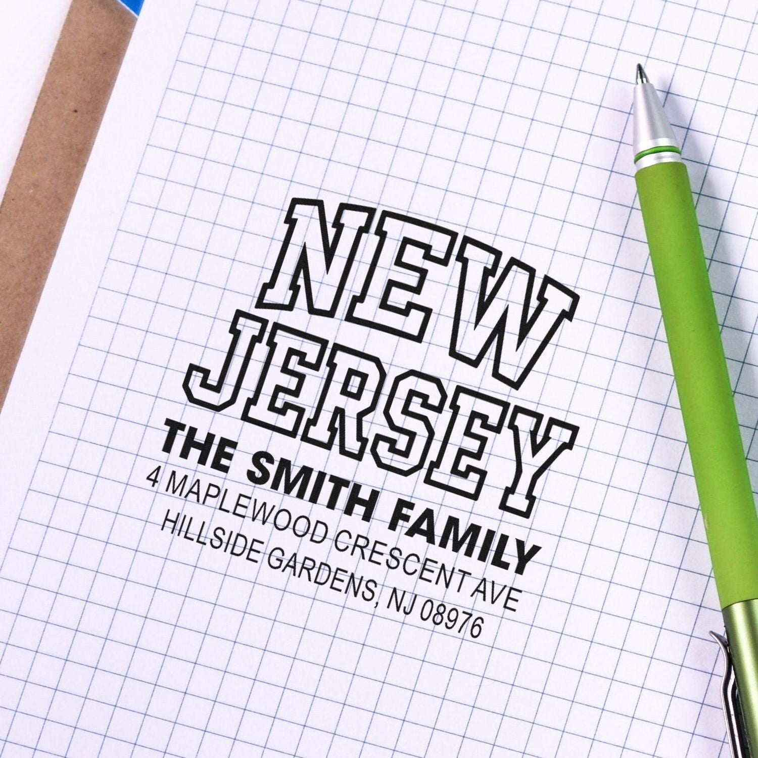 Custom rubber address stamp for the Smith family with New Jersey mailing address, stamped on graph paper.