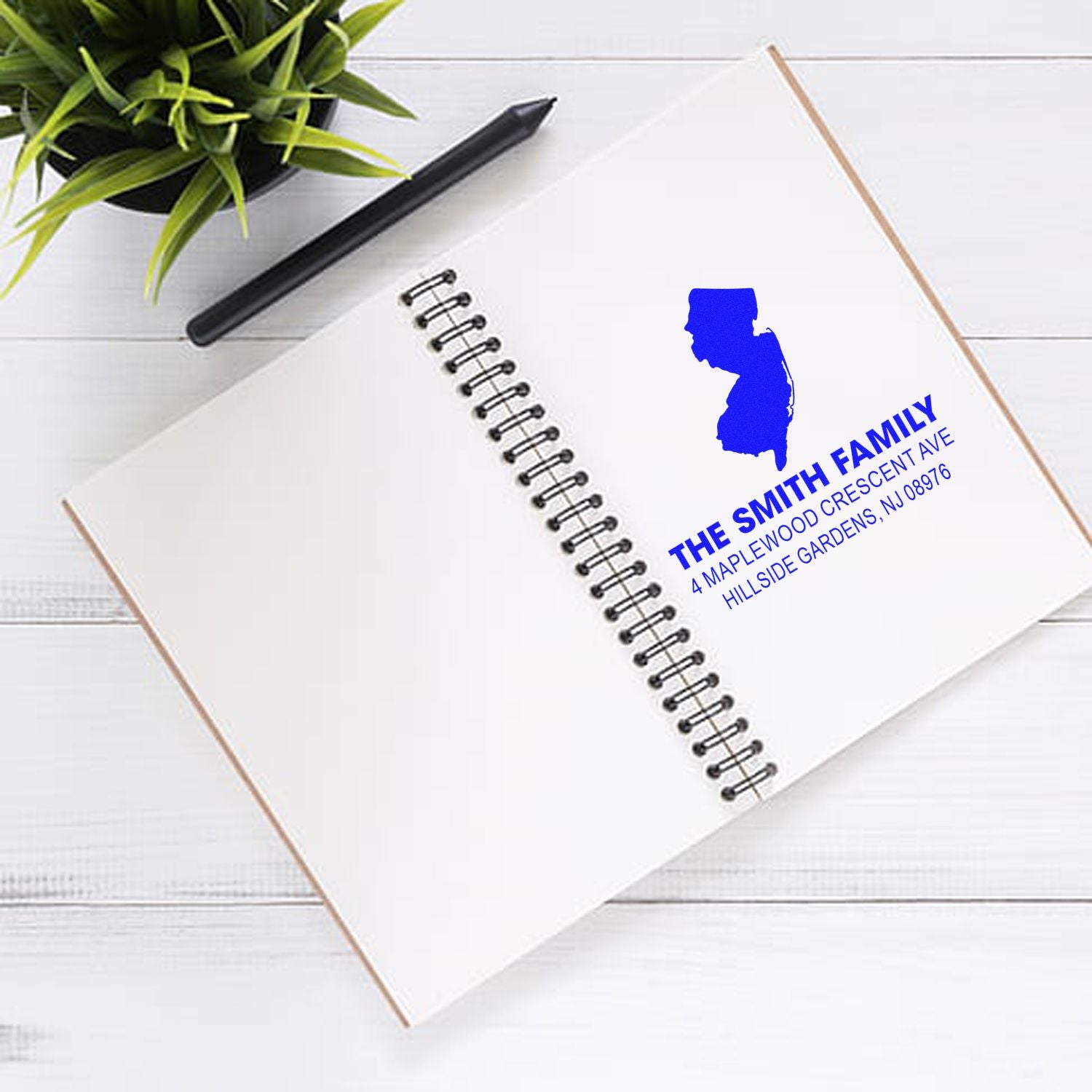 Custom rubber return address stamp for The Smith Family with blue New Jersey silhouette and personalized address imprint.