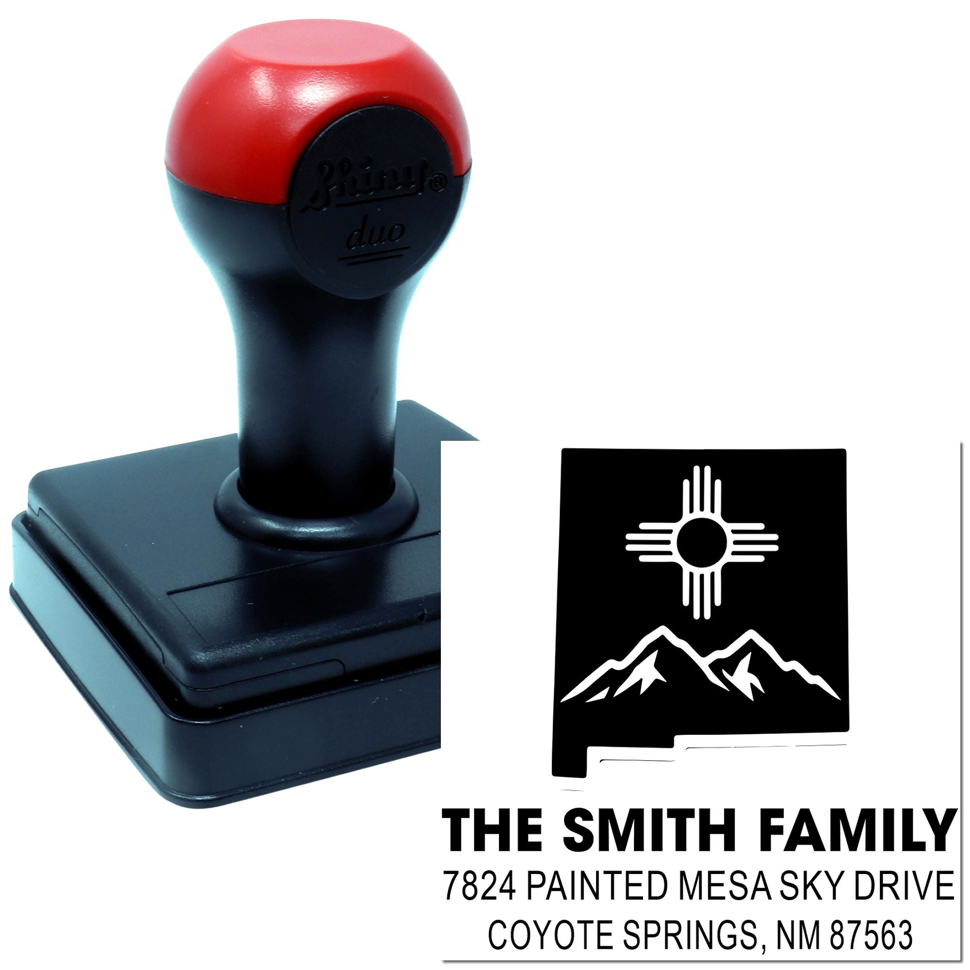 Custom self-inking rubber address stamp for The Smith Family, Coyote Springs, NM 87563 with mountain design.