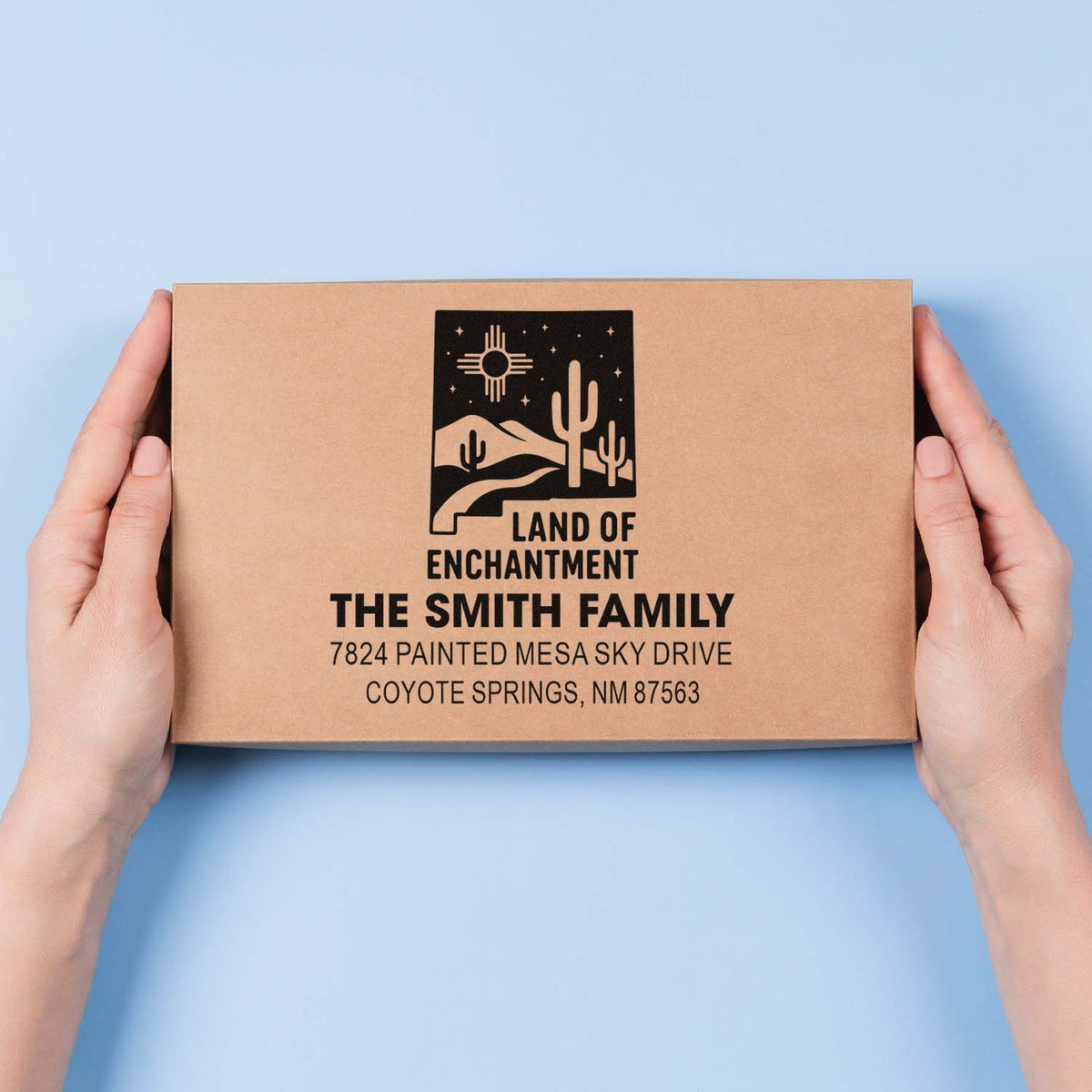 Custom rubber stamp impression on shipping box with logo, family name, and return address.