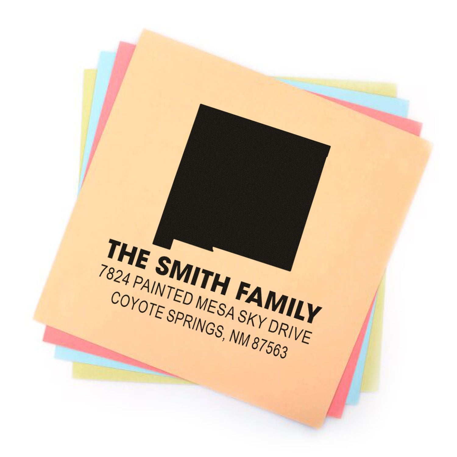 Custom return address rubber stamp for The Smith Family with name and address on colorful paper samples.