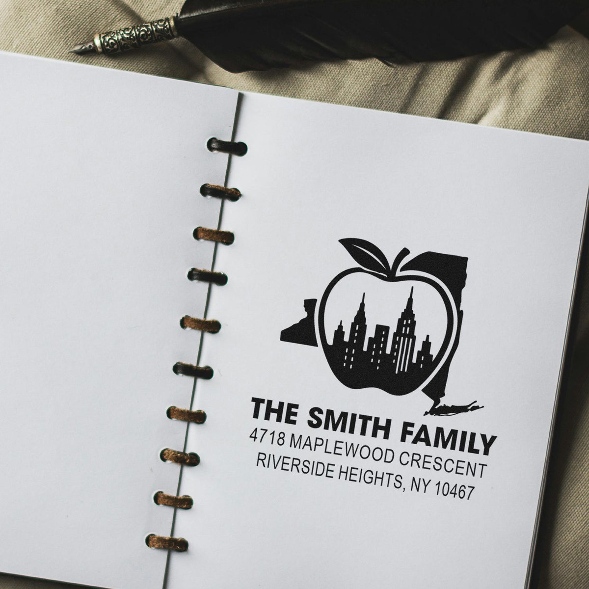 Personalized return address rubber stamp for The Smith Family with city skyline apple logo