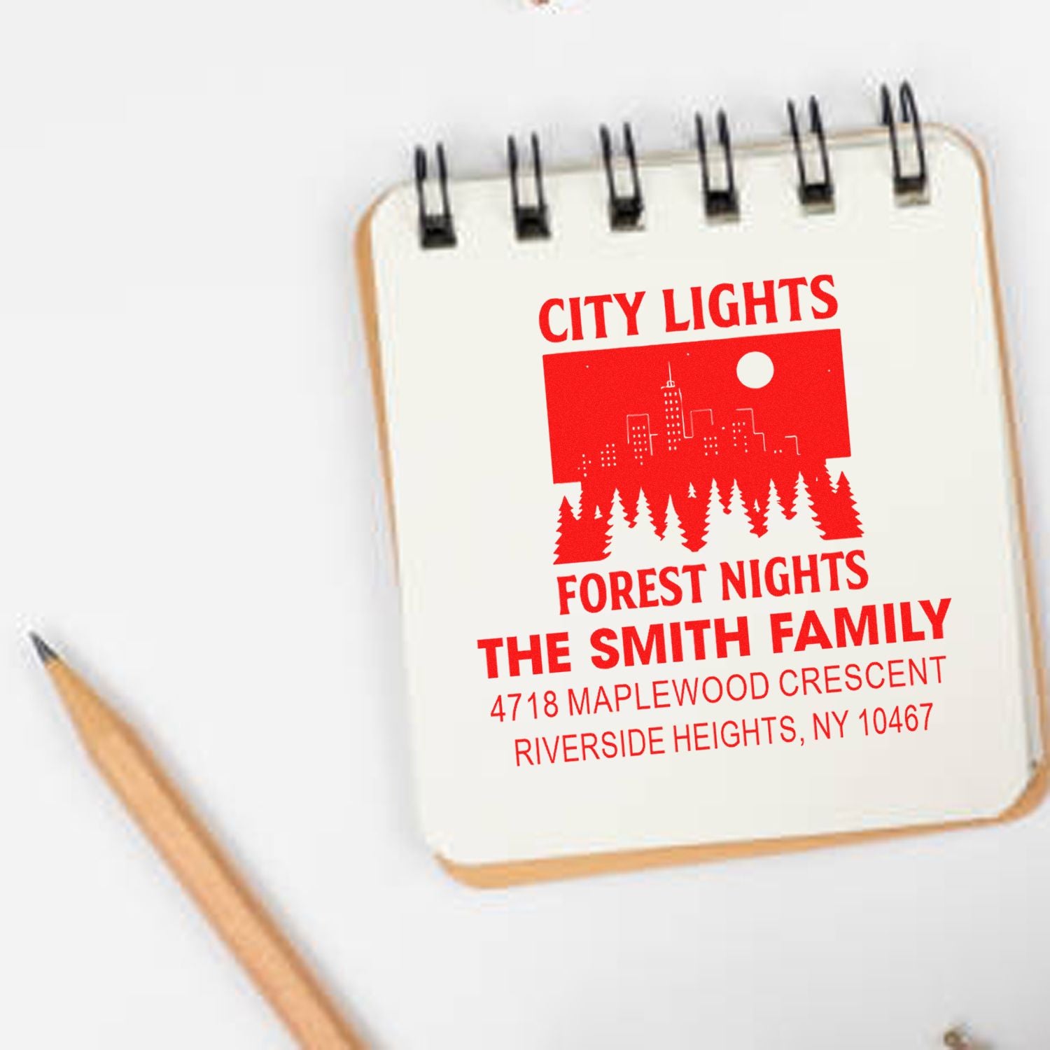 Personalized family address rubber stamp design with city skyline and forest motif for custom stationery.