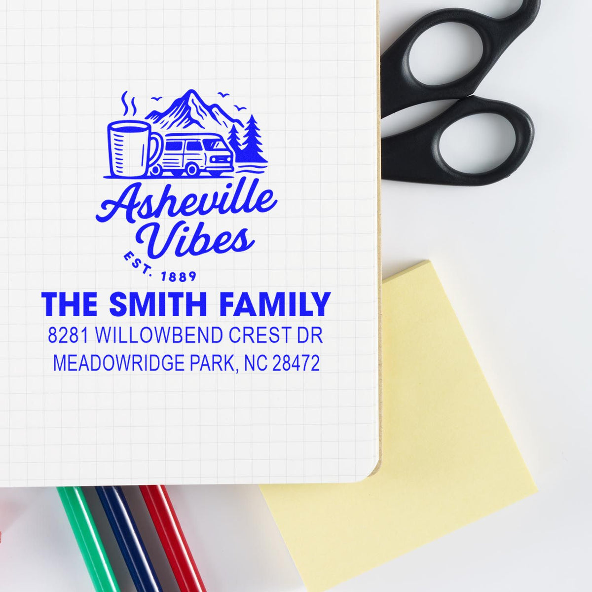 Custom return address rubber stamp with Asheville Vibes design, featuring Smith family name and address on notebook paper.