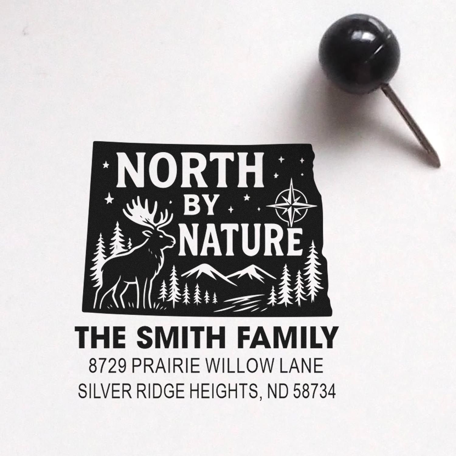 Custom return address rubber stamp for The Smith Family with North By Nature deer, trees, and mountain design.