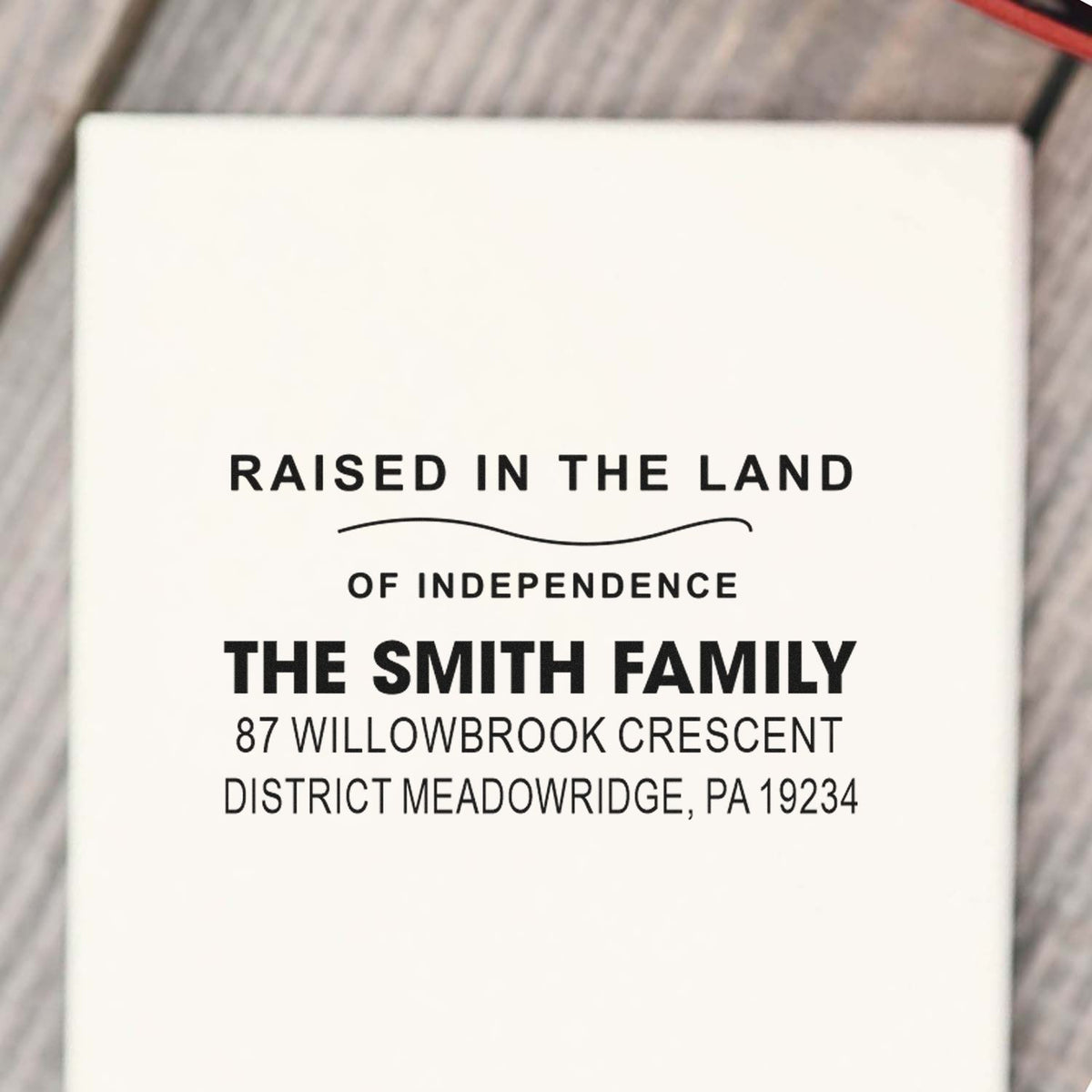 Personalized family address rubber stamp reading Raised in the Land of Independence for The Smith Family in Meadowridge, PA.