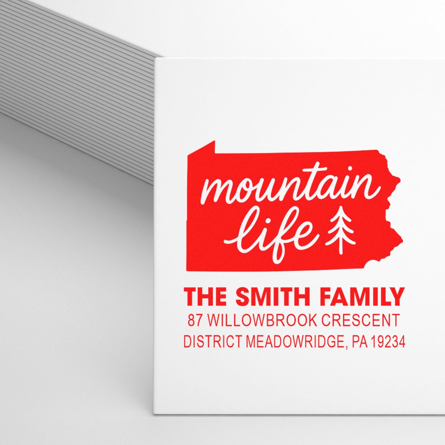 Custom rubber stamp design with mountain life logo, Smith family name, and return address in red